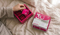 Hand taking a RevitaPlus Women’s 30+ daily supplement sachet from an open Beauty Pack box