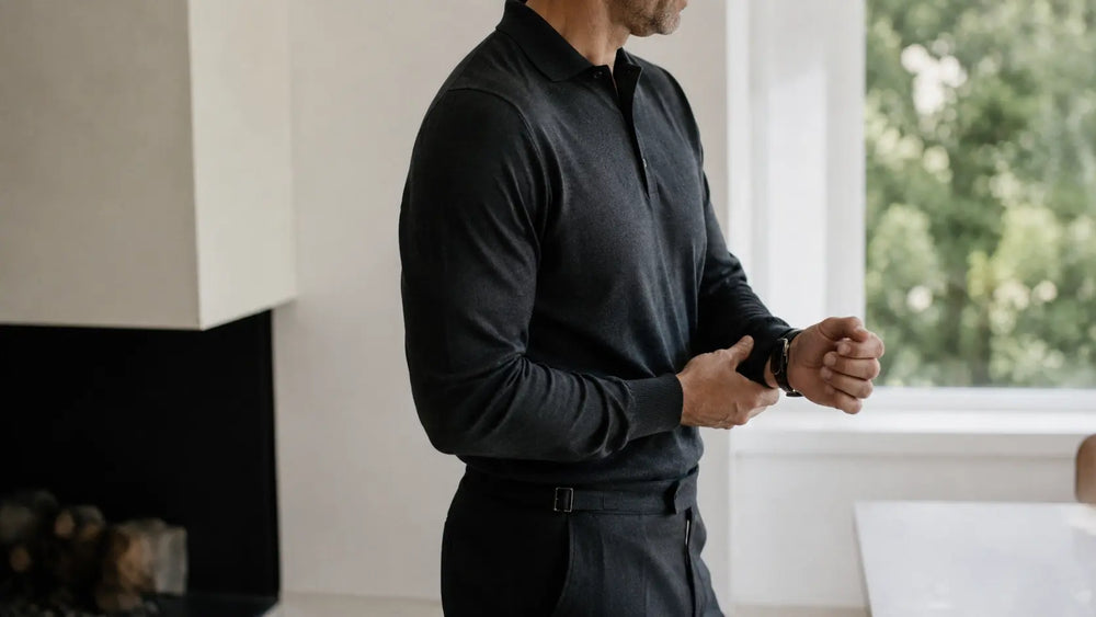 Man adjusting his watch in a bright minimalist space for a composed daily wellness moment
